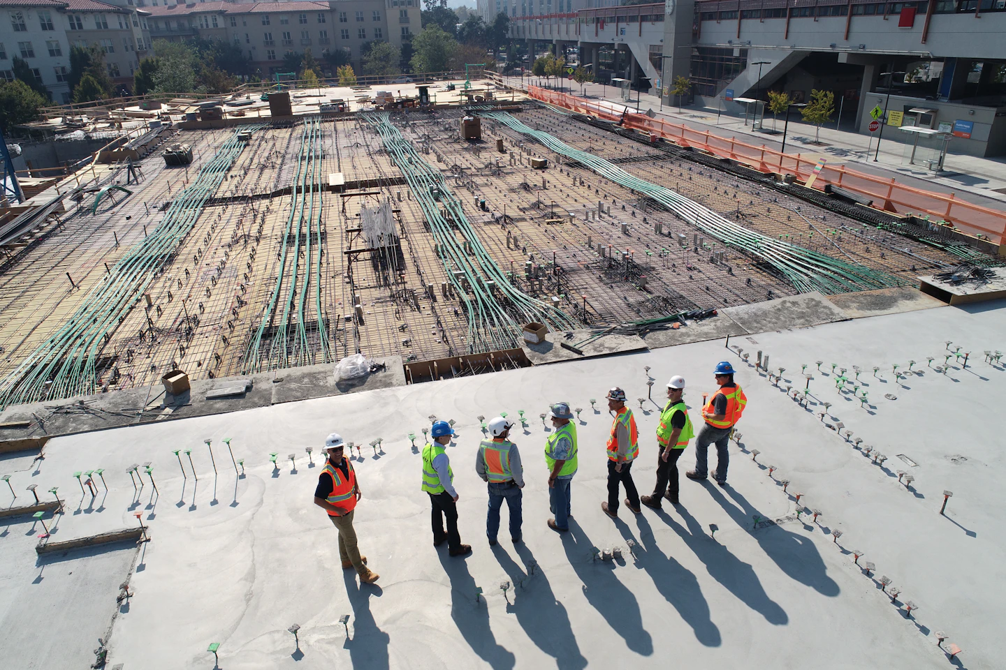 Construction crew reviewing a concrete building site